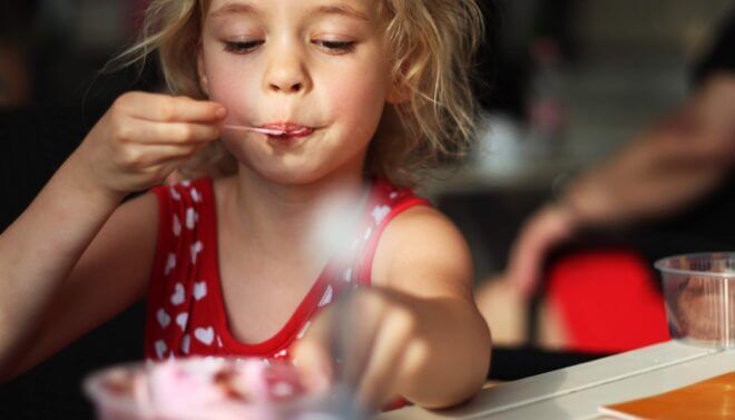 little girl eating at restaurant
